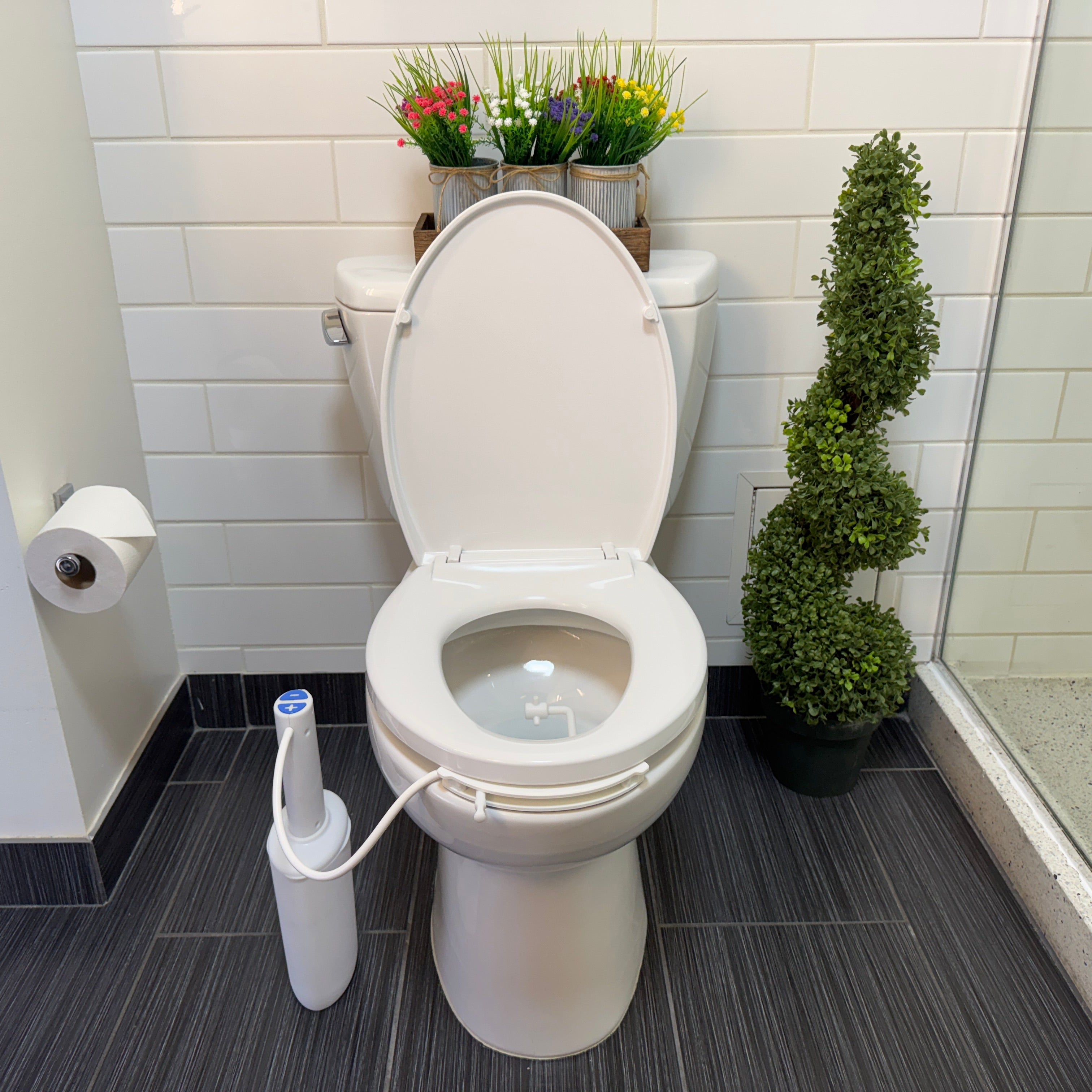 Traveler bidet mounted on hotel toilet